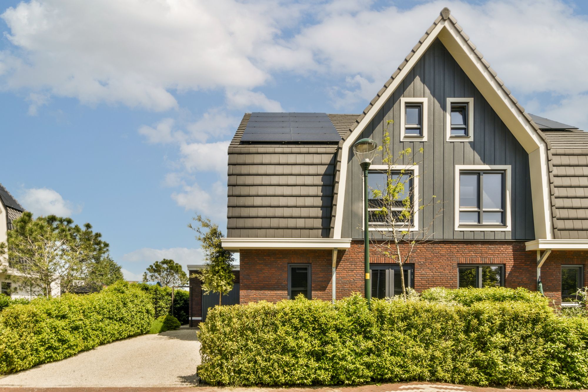 a brick house with a grey roof and a driveway blsghb6.jpg